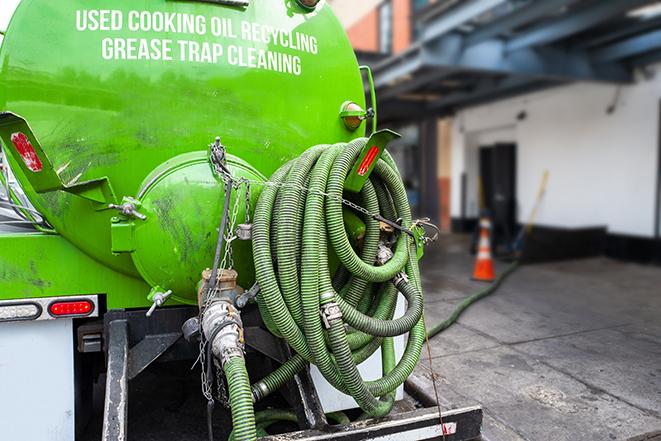 a grease trap being pumped by a sanitation technician in Coulee City